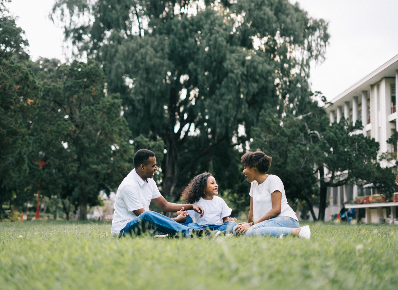 Family Sitting On Grass